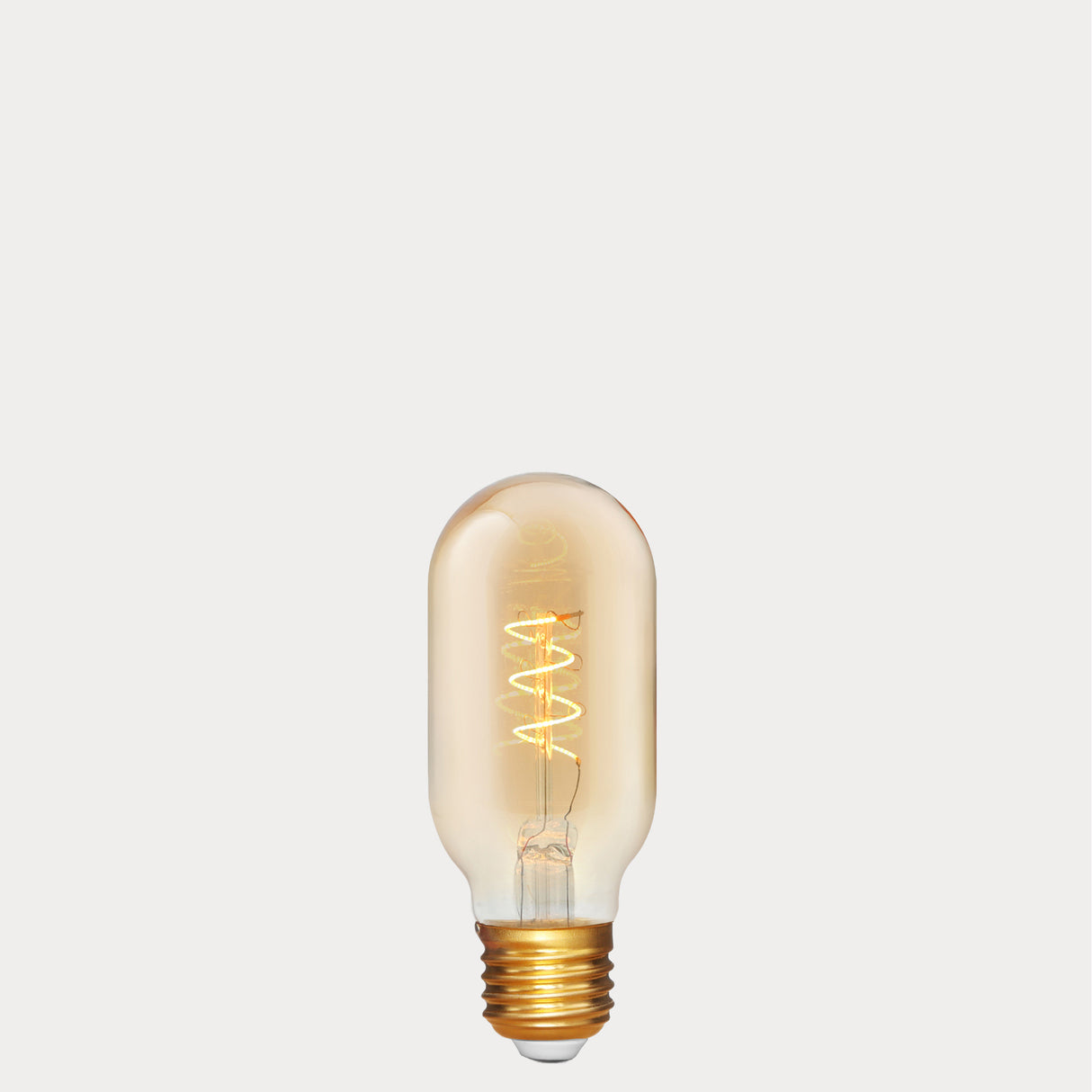 Dulora 4W Vintage Tubular Spiral LED Bulb E27 in Ultra Warm White glowing with warm spiral filament through amber tube