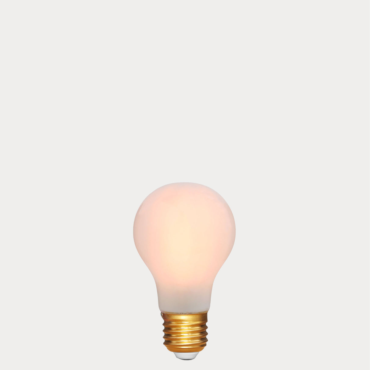 Dulora 6.5W E27 LED GLS bulb in frosted glass, glowing with 2200K extra warm white light
