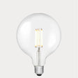Dulora 11W E27 LED globe bulb in clear glass, glowing with 3000K soft white light.