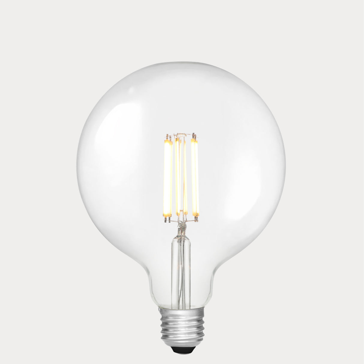 Dulora 11W E27 LED globe bulb in clear glass, glowing with 3000K soft white light.