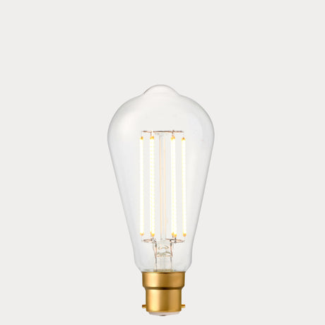 Dulora 4.2W Edison LED Bulb B22 in Extra Warm White illuminated showing warm amber glow through clear ST64 glass