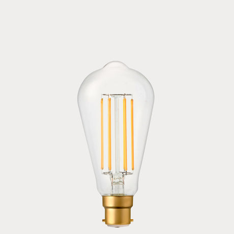 Dulora 4.2W Edison LED Bulb B22 in Extra Warm White with visible amber filaments in clear ST64 glass