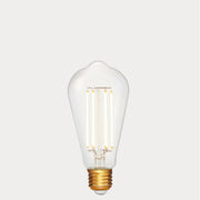 Dulora 4.2W Edison LED Bulb E27 in Extra Warm White illuminated showing warm amber glow through clear ST64 glass