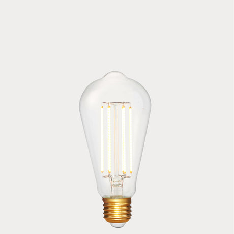 Dulora 4.2W Edison LED Bulb E27 in Extra Warm White illuminated showing warm amber glow through clear ST64 glass
