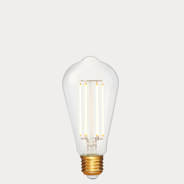 Dulora 4.2W Edison LED Bulb E27 in Extra Warm White illuminated showing warm amber glow through clear ST64 glass
