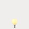 Dulora 4W 24 Volt DC Fancy Round LED Bulb E14 Opal in Warm White glowing softly through opal glass