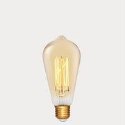 Dulora 4W Edison Vintage LED Bulb E27 in Ultra Warm White glowing deep amber through vintage ST64 glass