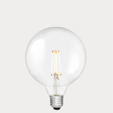 Dulora 7W E27 LED globe bulb in clear glass, glowing with 2700K warm white light.