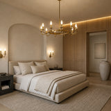 A luxury bedroom featuring multiple Dulora Frosted Dimmable Candle LED Bulbs emitting warm 2700K light in a modern brass multi-light bedroom chandelier.
